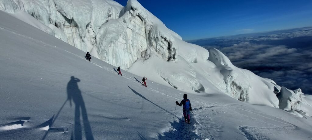 Roped team climbing the Cotopaxi glacier with professional guides in Ecuador