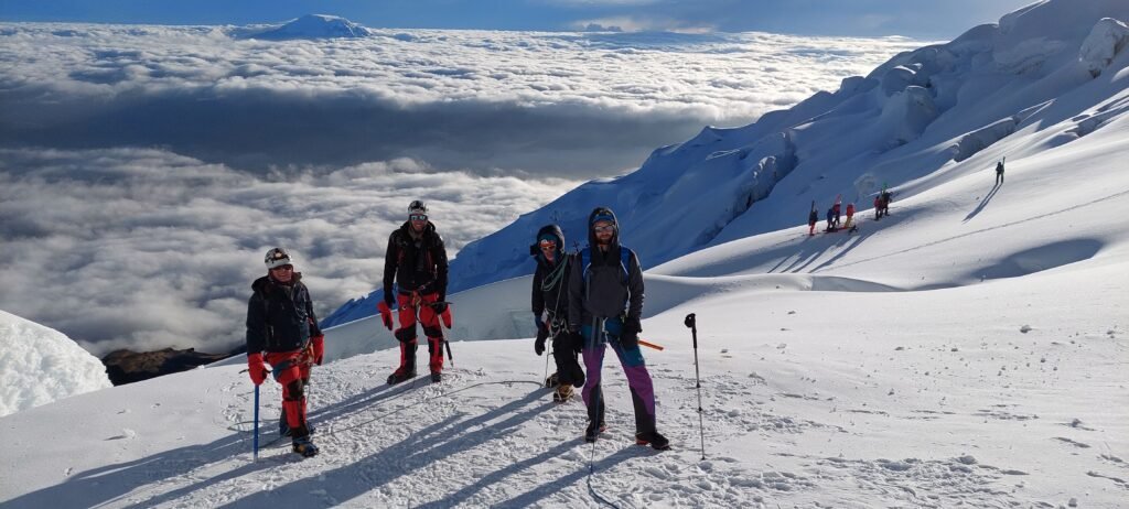 Guided climbers approaching Cotopaxi summit across the glacier