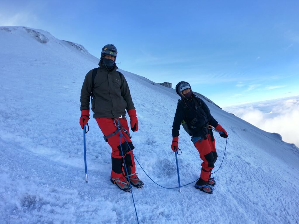 Climbers ascending the upper glacier on Cotopaxi during a guided climb